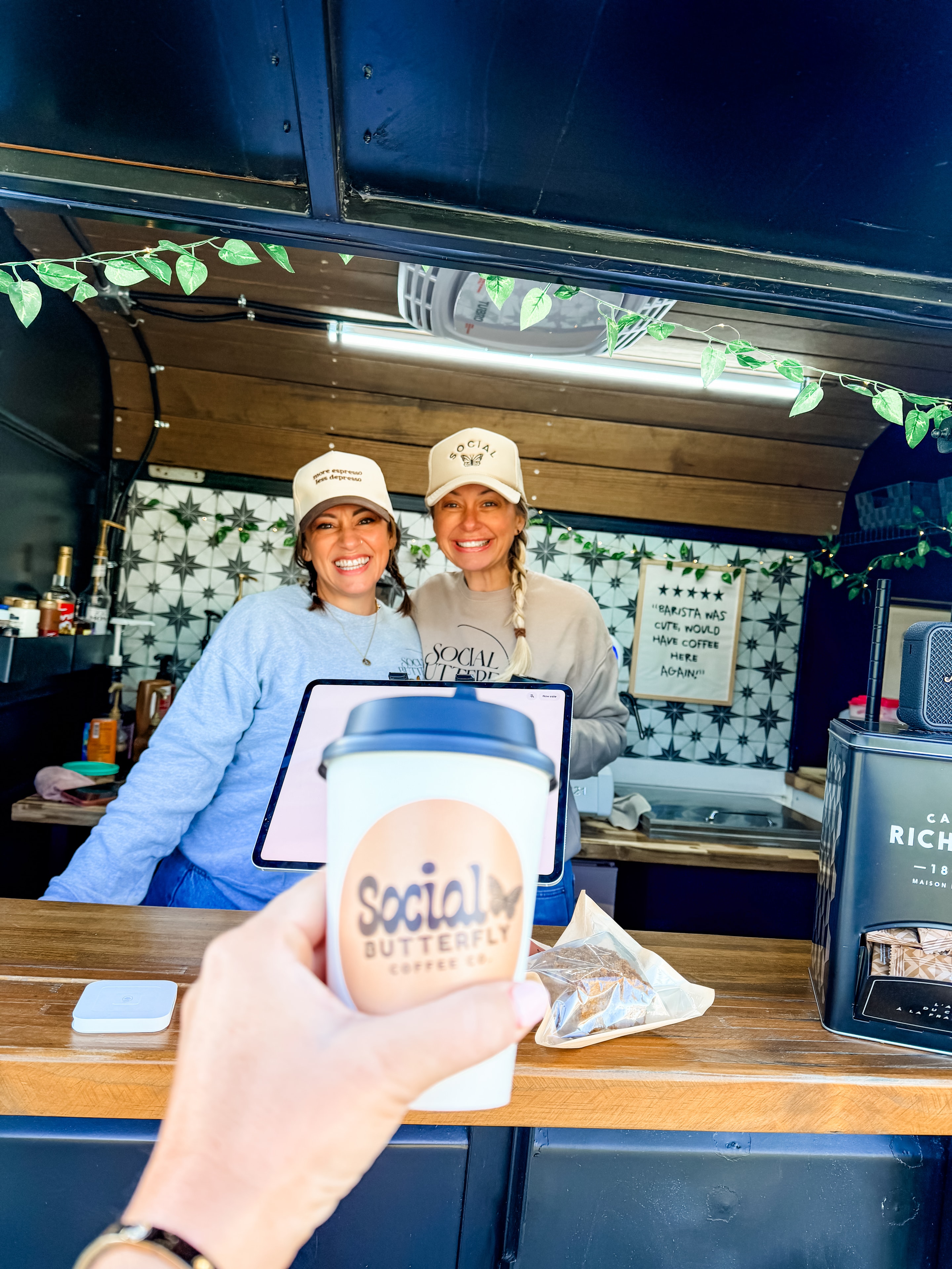 Social Butterfly Coffee Co baristas smiling through the trailer window